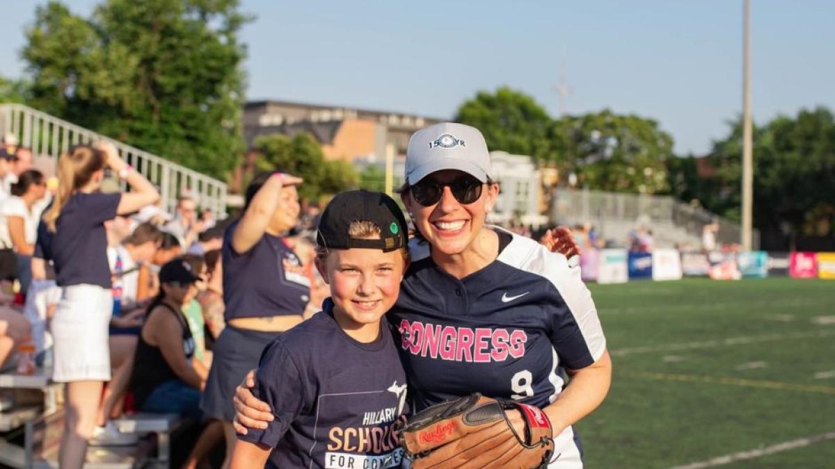 Rep. Scholten and son at the Congressional Softball Game