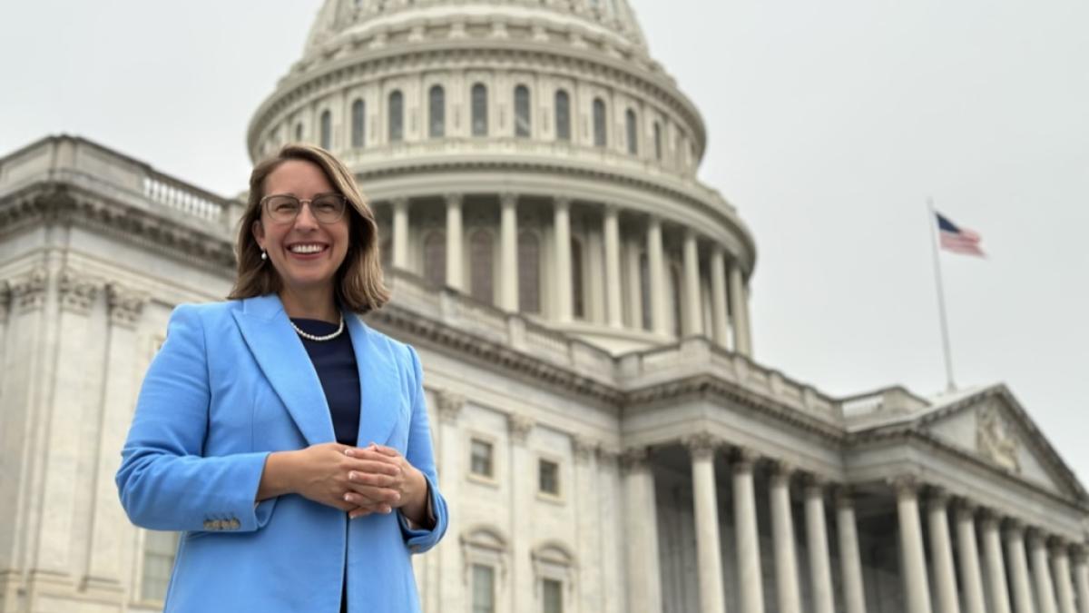 Congresswoman Hillary Scholten stands in front of the United States Capitol.