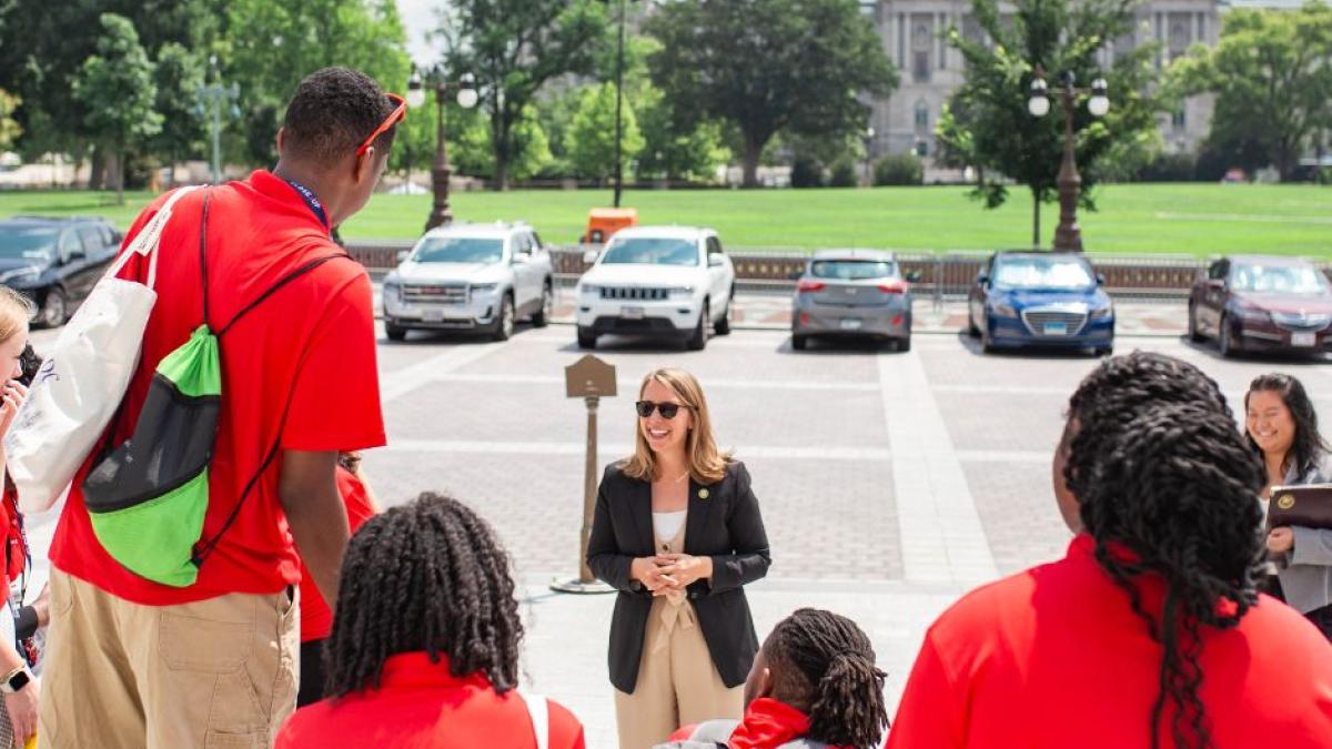 Michigan students speak with Rep. Scholten on the steps of the Capitol